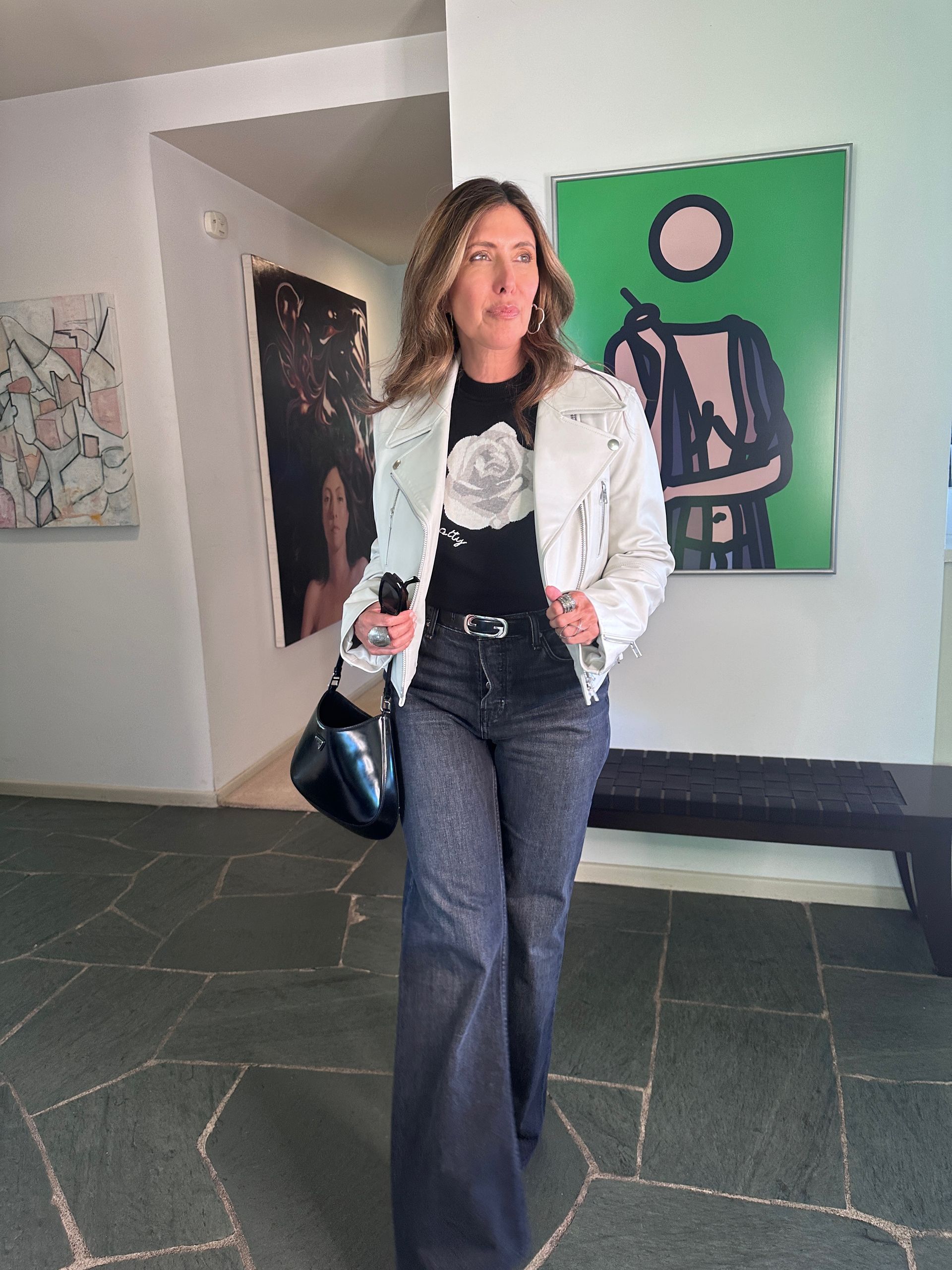 Melissa Meyers wears a black sweater with a white rose
