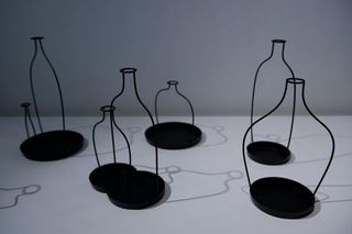 Black steel framed bottles photographed against a white background