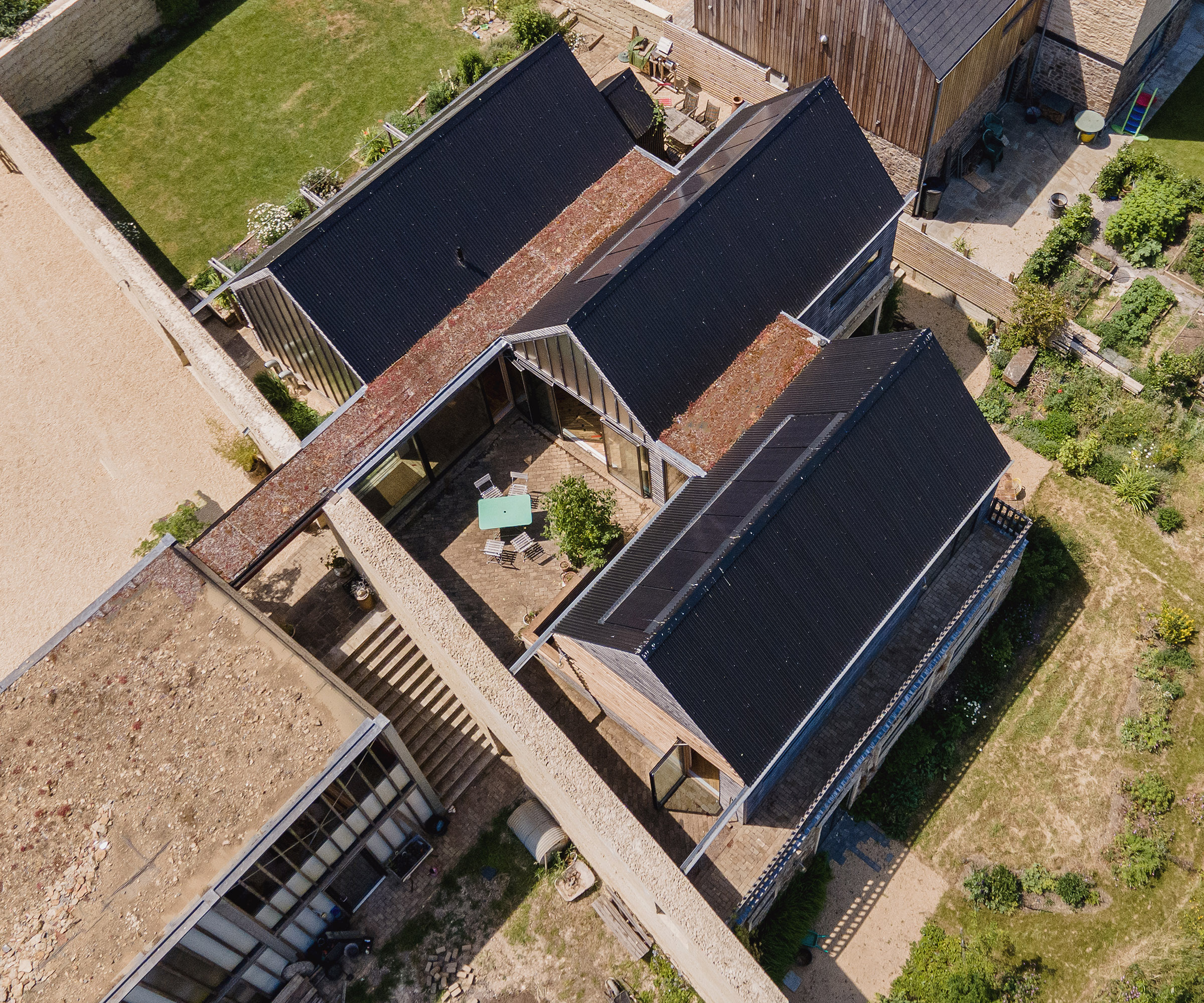 An aerial drone shot of three self build buildings