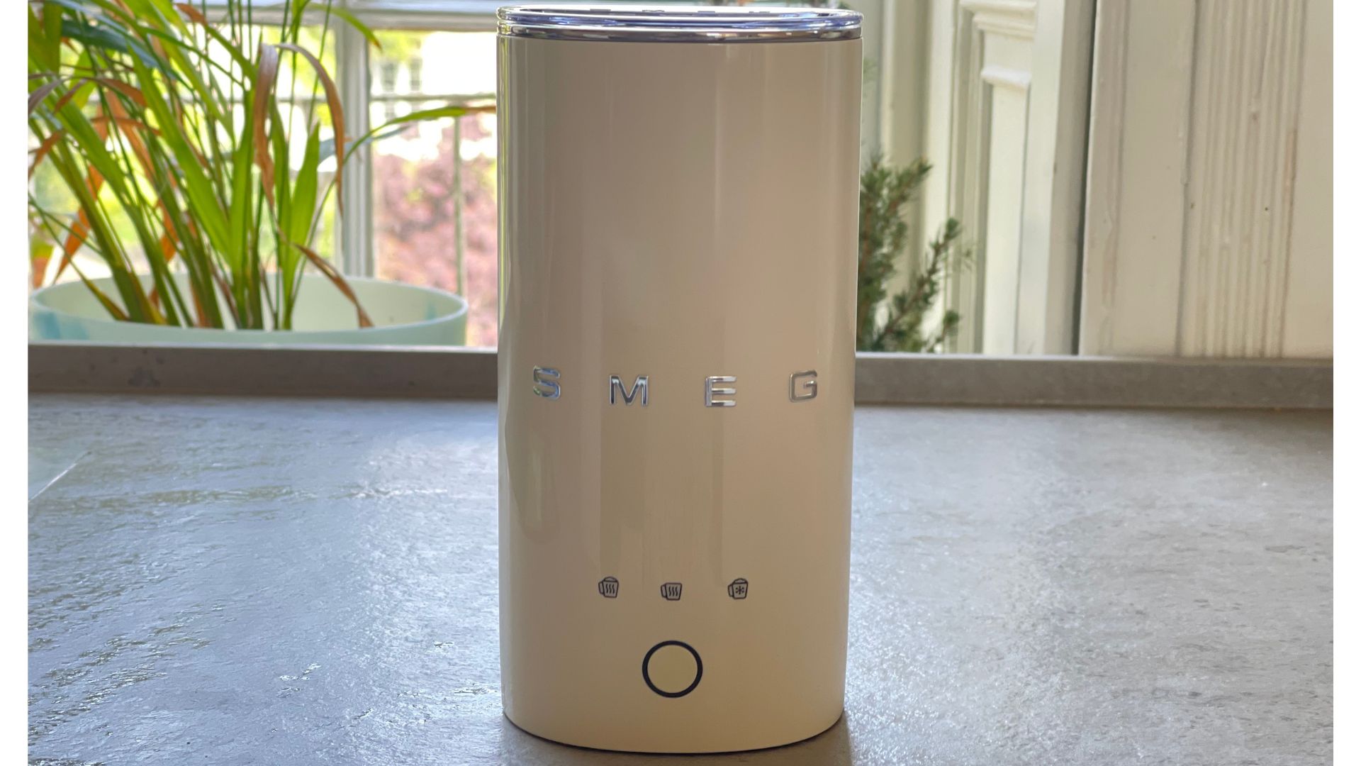 Smeg mini milk frother on a counter
