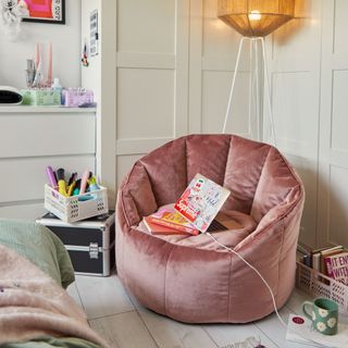 Pink armchair with laptop on top