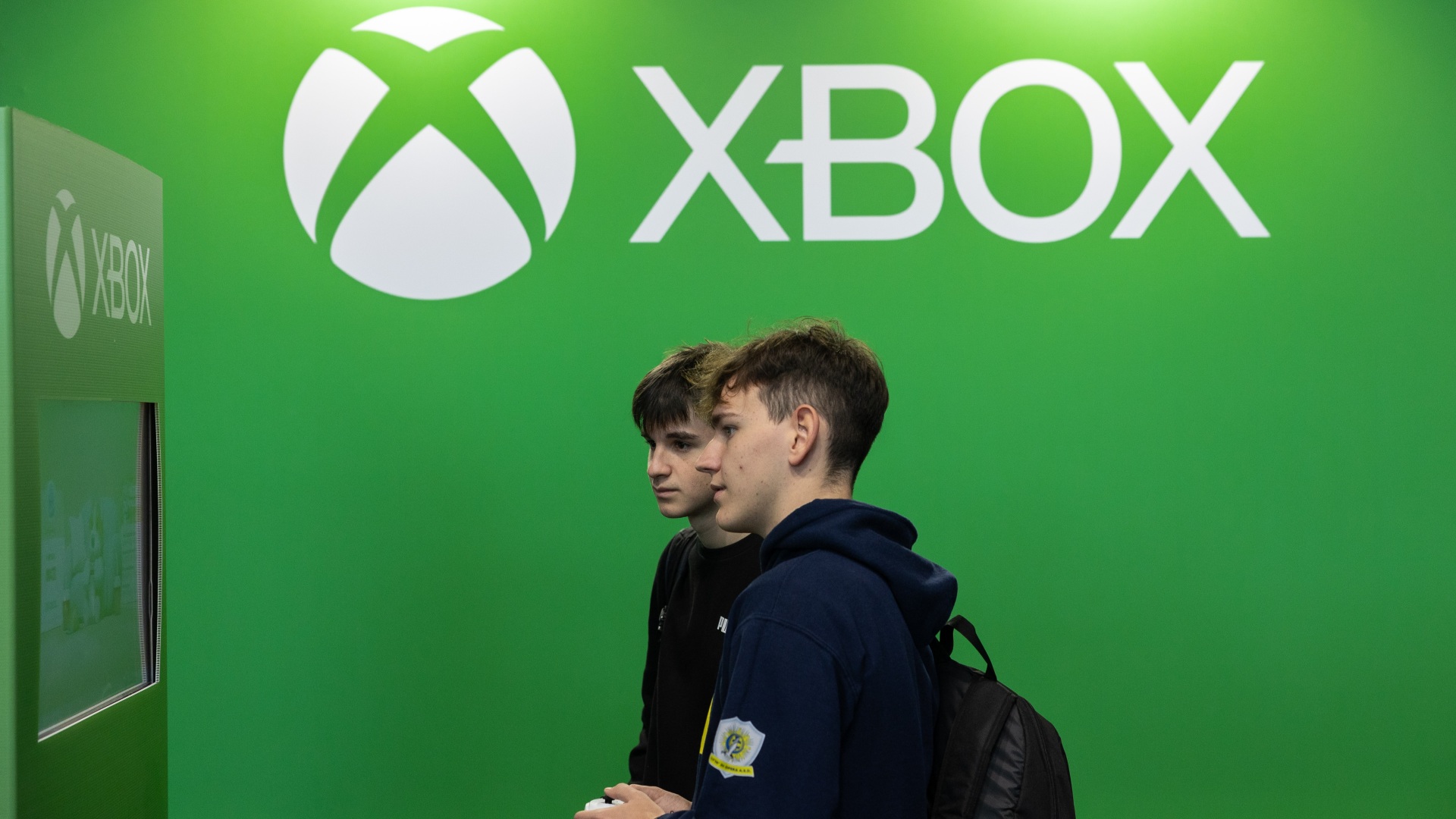 Two people play video games for Microsoft's Xbox gaming system.
