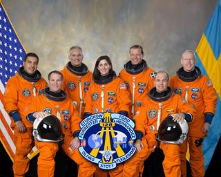 Seated are NASA astronauts Rick Sturckow (right), commander; and Kevin Ford, pilot. From the left (standing) are astronauts Jose Hernandez, John "Danny" Olivas, Nicole Stott, European Space Agency's Christer Fuglesang and Patrick Forrester, all mission specialists