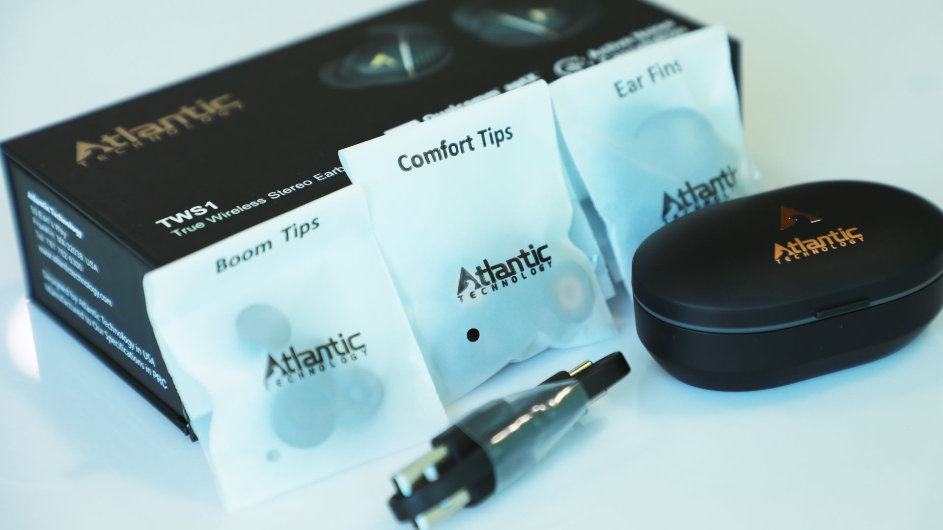 Atlantic Technology TWS1 earbuds and accessories on white background