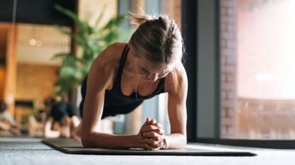 A woman doing a plank at home