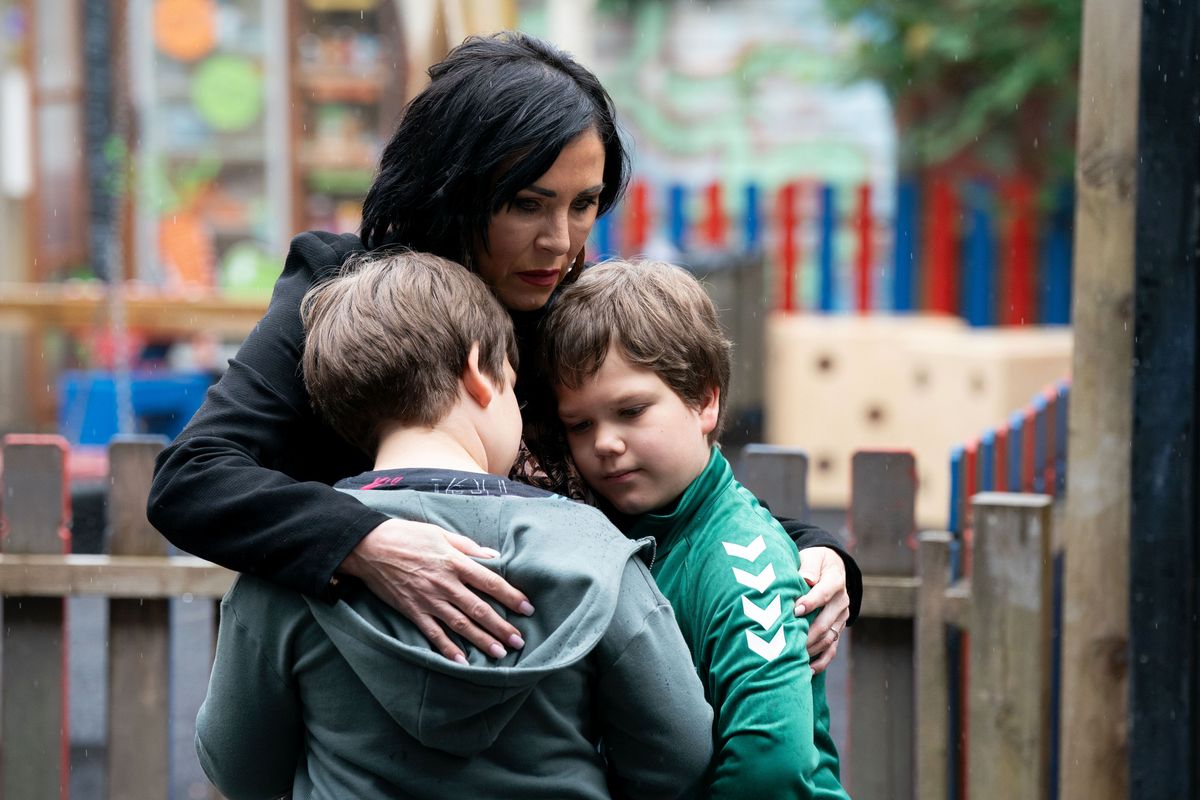 Kat Slater hugging her twin boys Bert and Ernie in the playground