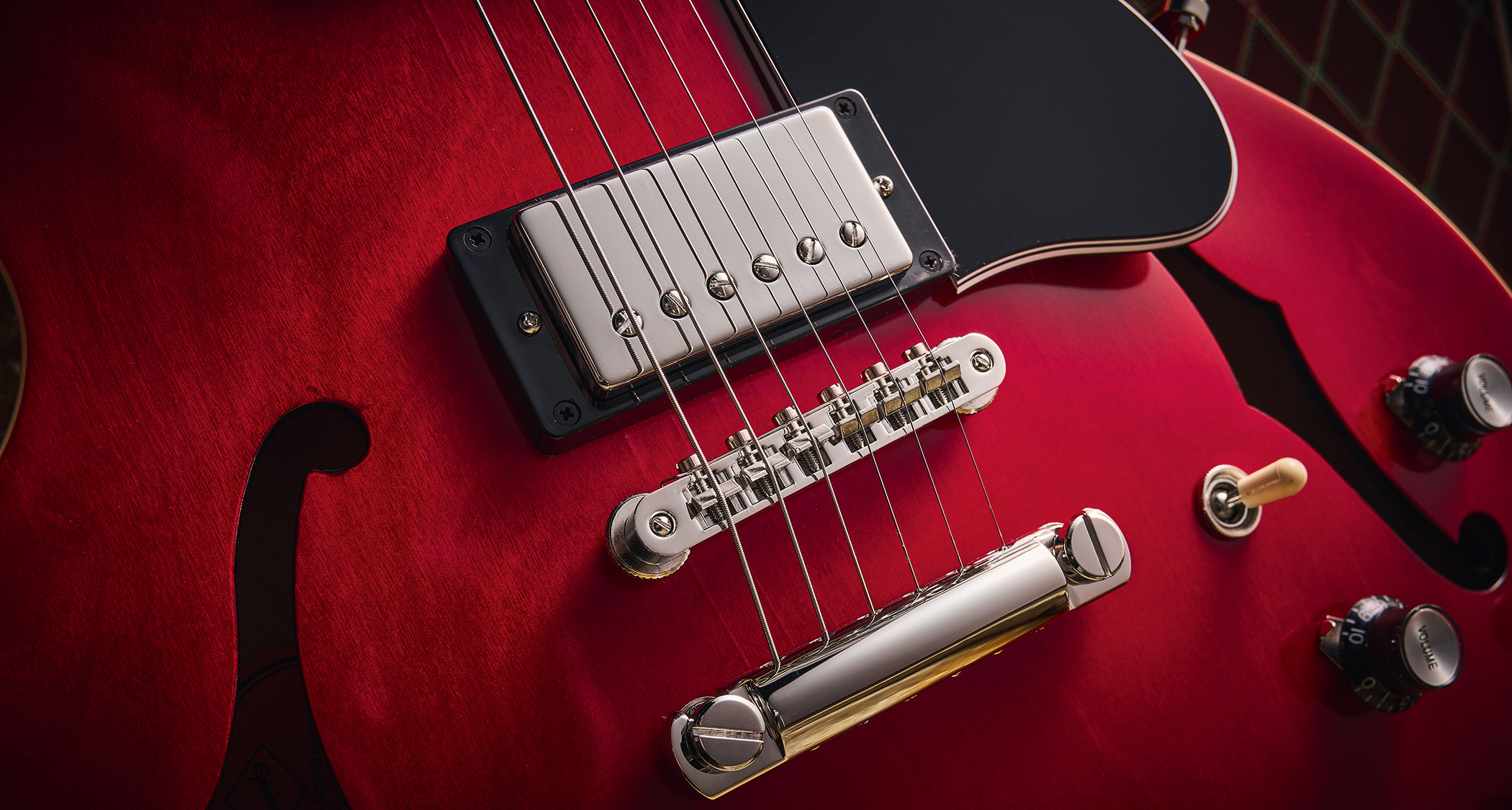 Epiphone Inspired By Gibson Custom 1962 ES-335 Reissue: the handsome semi-hollow electric is finished in Sixties Cherry and is photographed against various backgrounds.