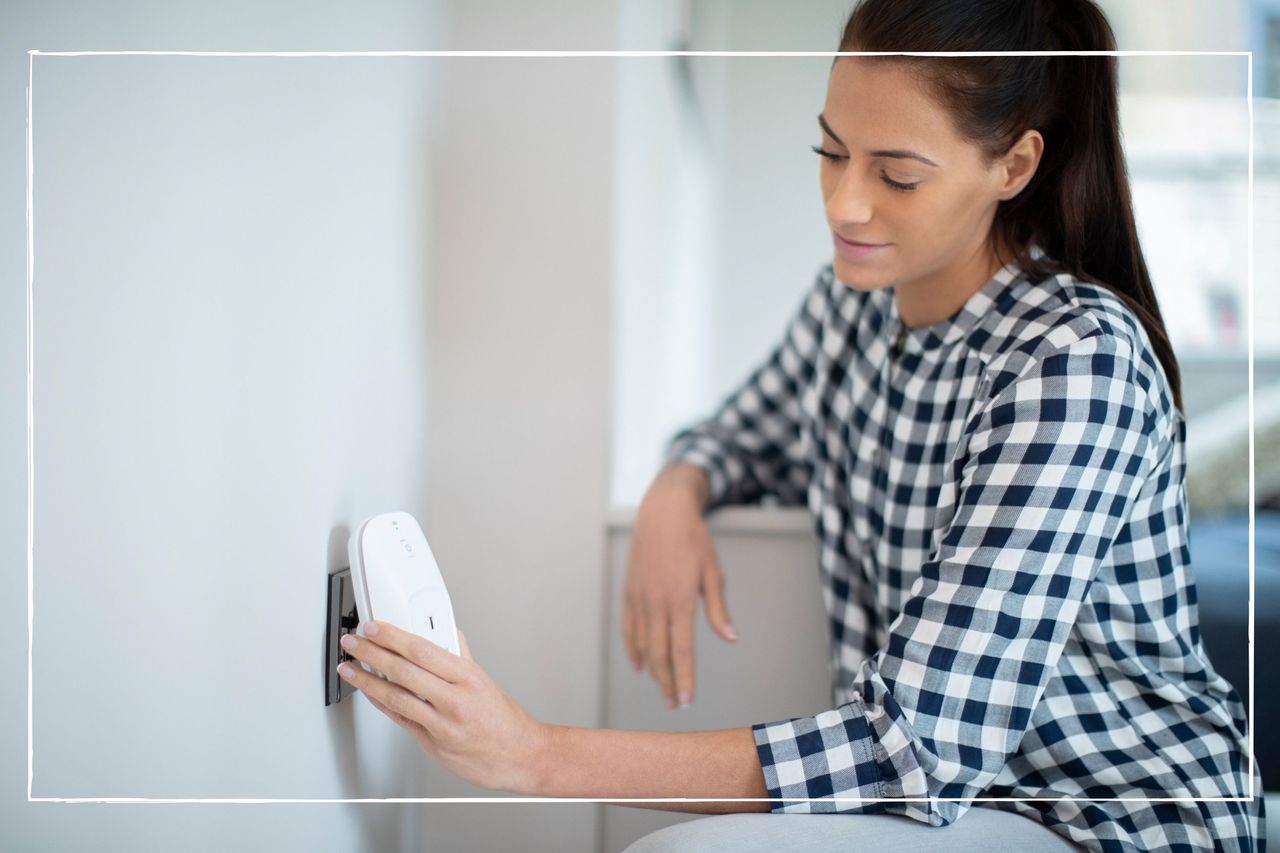 Woman plugging smart plug into electrical socket