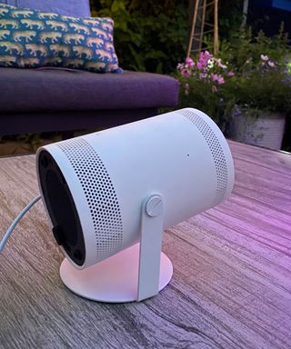 close up image of the Samsung Freestyle projector on a garden table