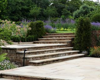 A design for a sloping garden using steps to as a feature by Bowles & Wyer