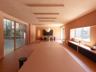 Elongated room with long table and dim lighting