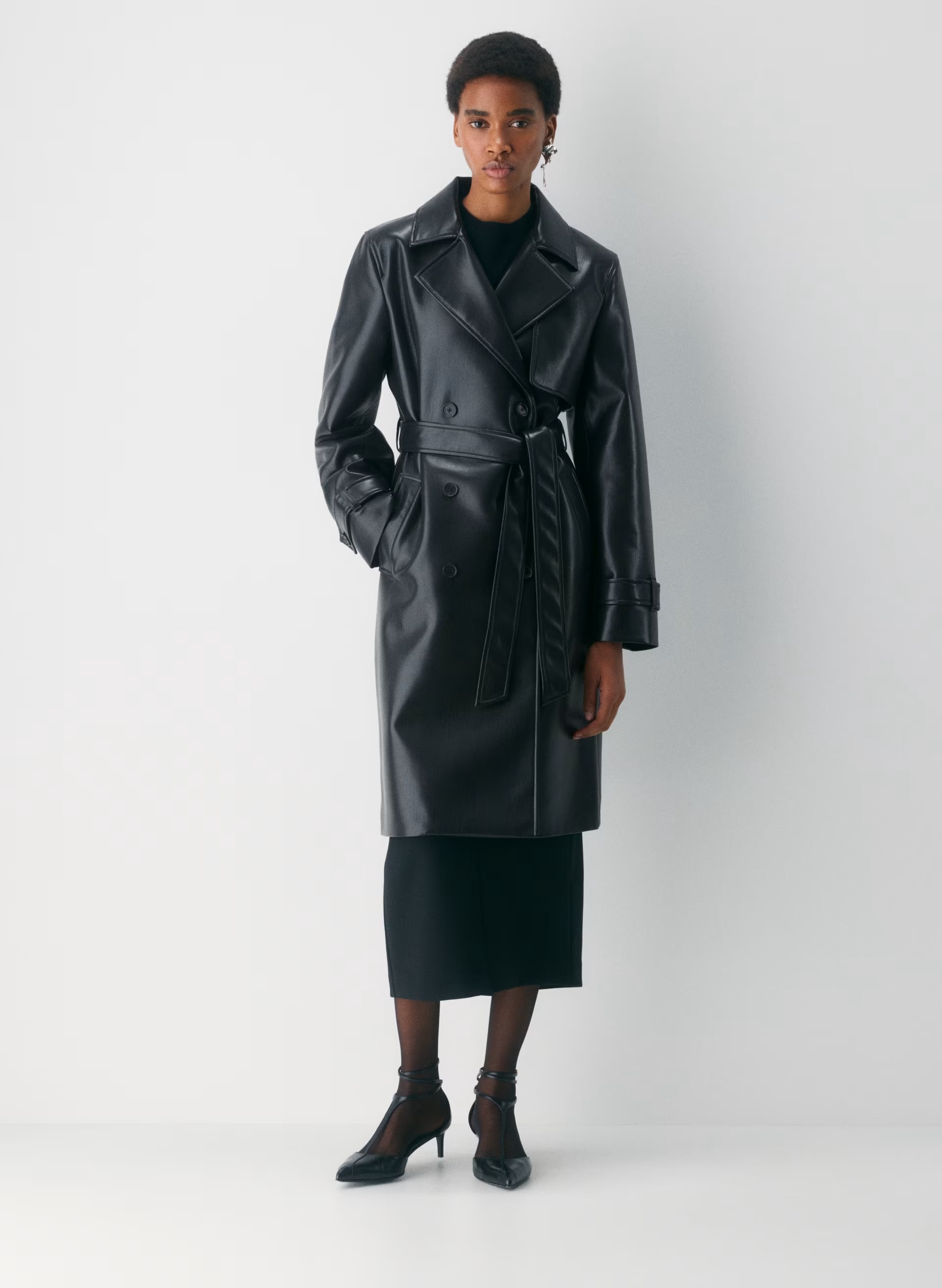 model wears black leather trench coat