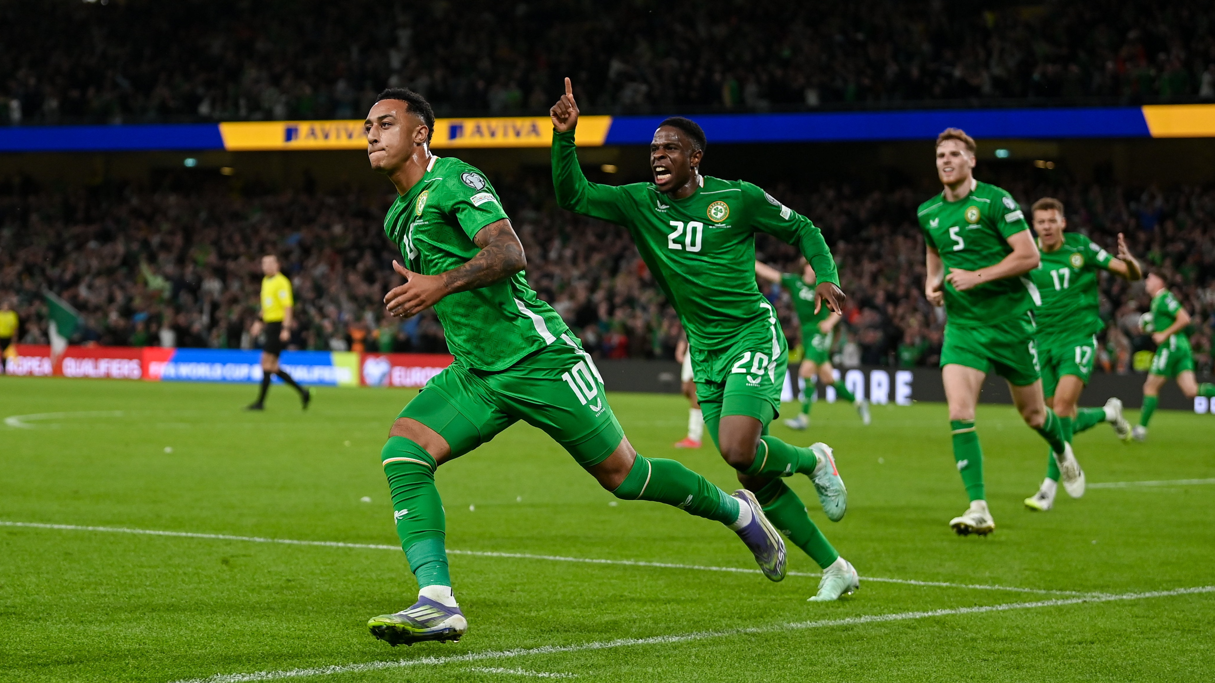 Adam Idah of Republic of Ireland, 10, celebrates with teammate Chiedozie Ogbene, 20, after scoring their side's second goal during the FIFA World Cup 2026 Group F qualifying match between Republic of Ireland and Hungary at the Aviva Stadium in Dublin.
