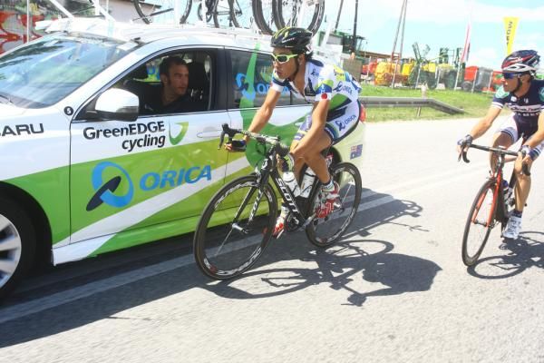 Fumiyuki Beppu (Orica GreenEdge Cycling Team) confers with his directeur sportif while out on the attack in a three-man break.