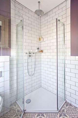 bathroom with white tiles and hand shower