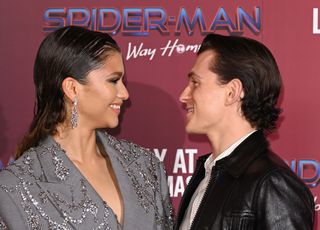 Tom Holland and Zendaya look lovingly at one another on the red carpet