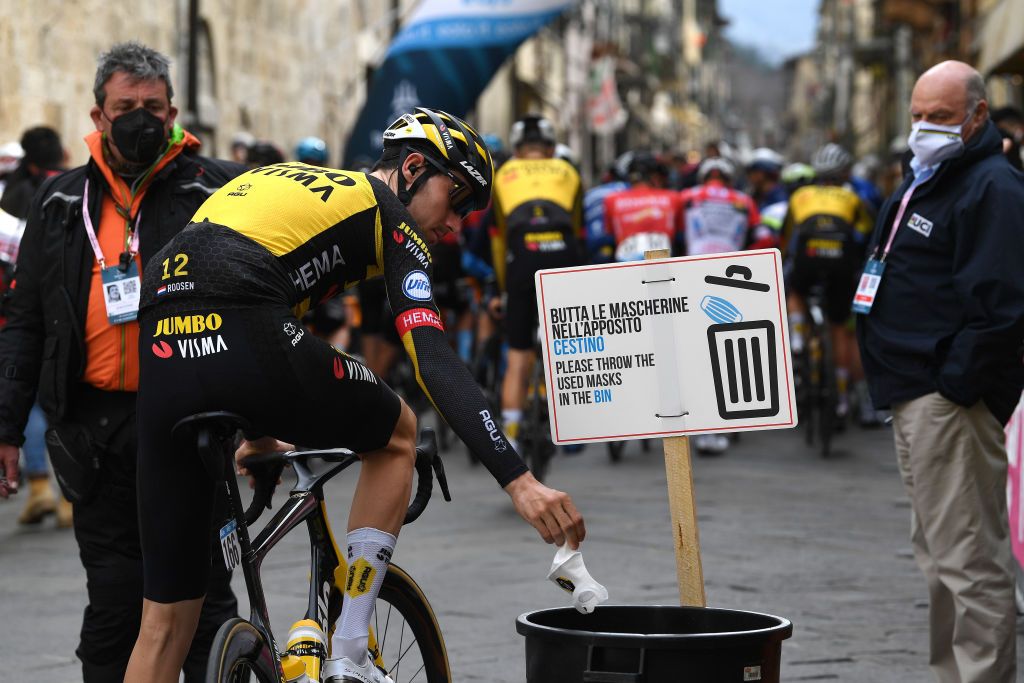 Riders throw away their masks at the Tirreno-Adriatico start line