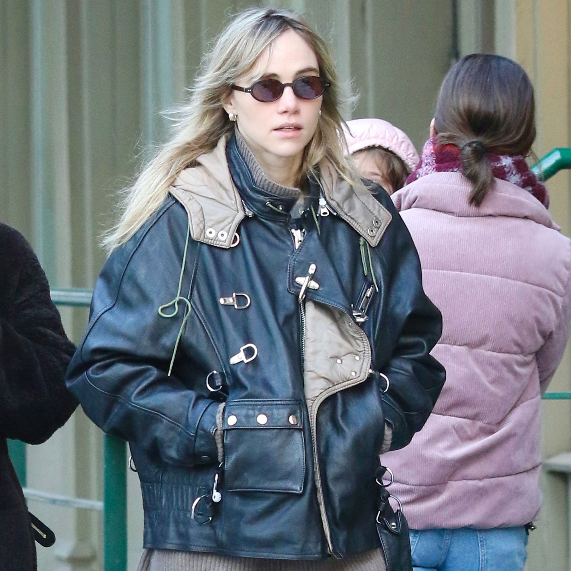 Suki Waterhouse wears a bomber jacket, jeans, and Nike sneakers