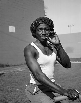 Man is cycling and also smoking