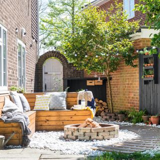 wooden benches with fireplace cushion and green plant