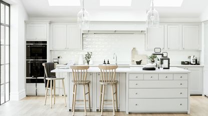 All-white kitchen with ivory worktops and cupboards