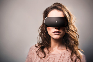 An image of a woman wearing a mock up of Apple's mixed-reality headset