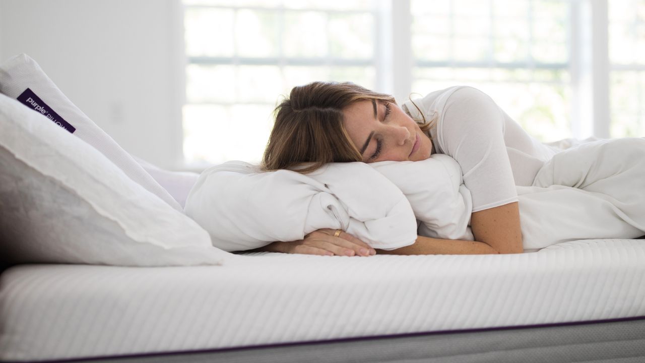 Girl asleep on Purple mattress