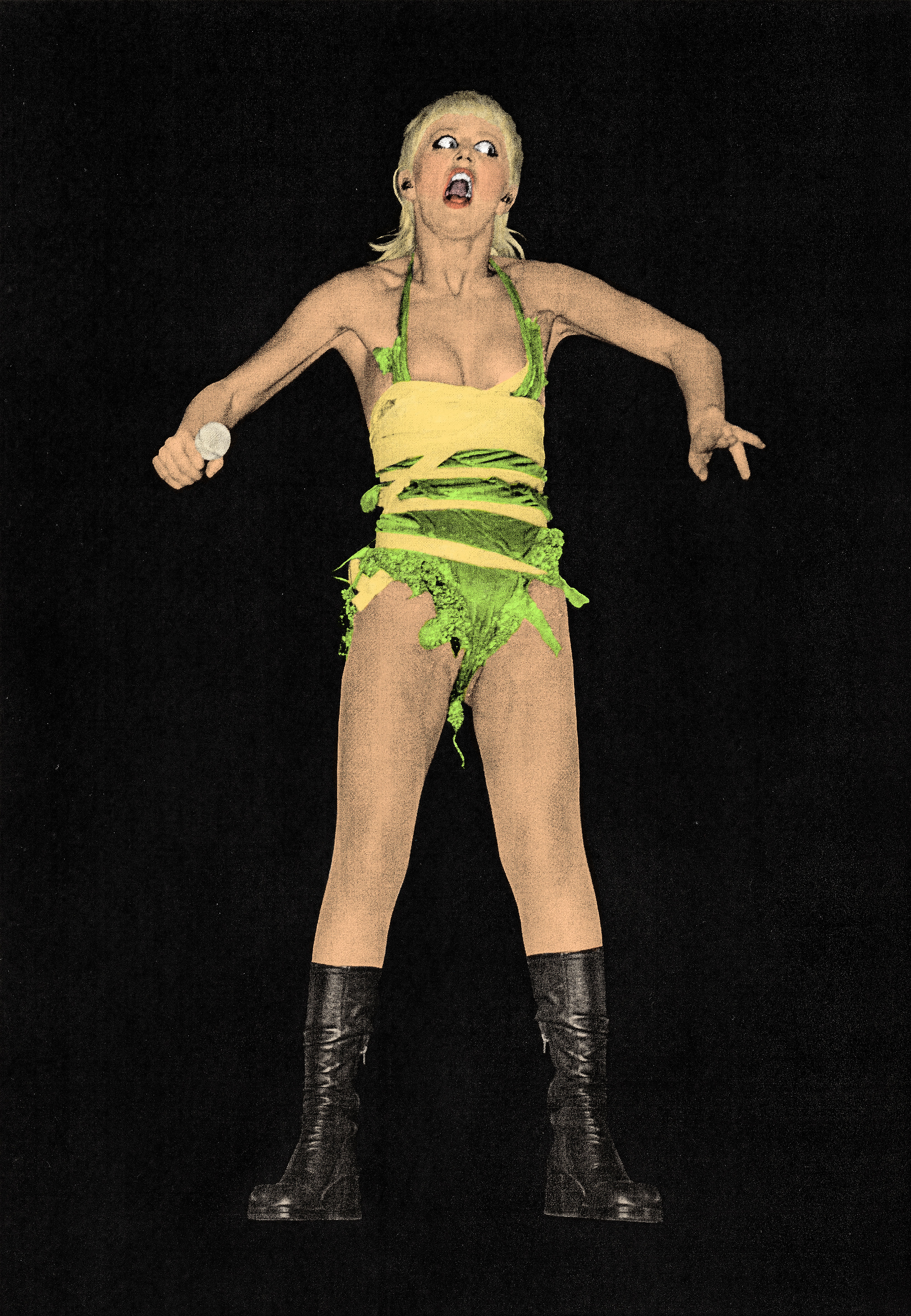 A blonde woman wearing a green and yellow outfit and black shoes with her mouth open