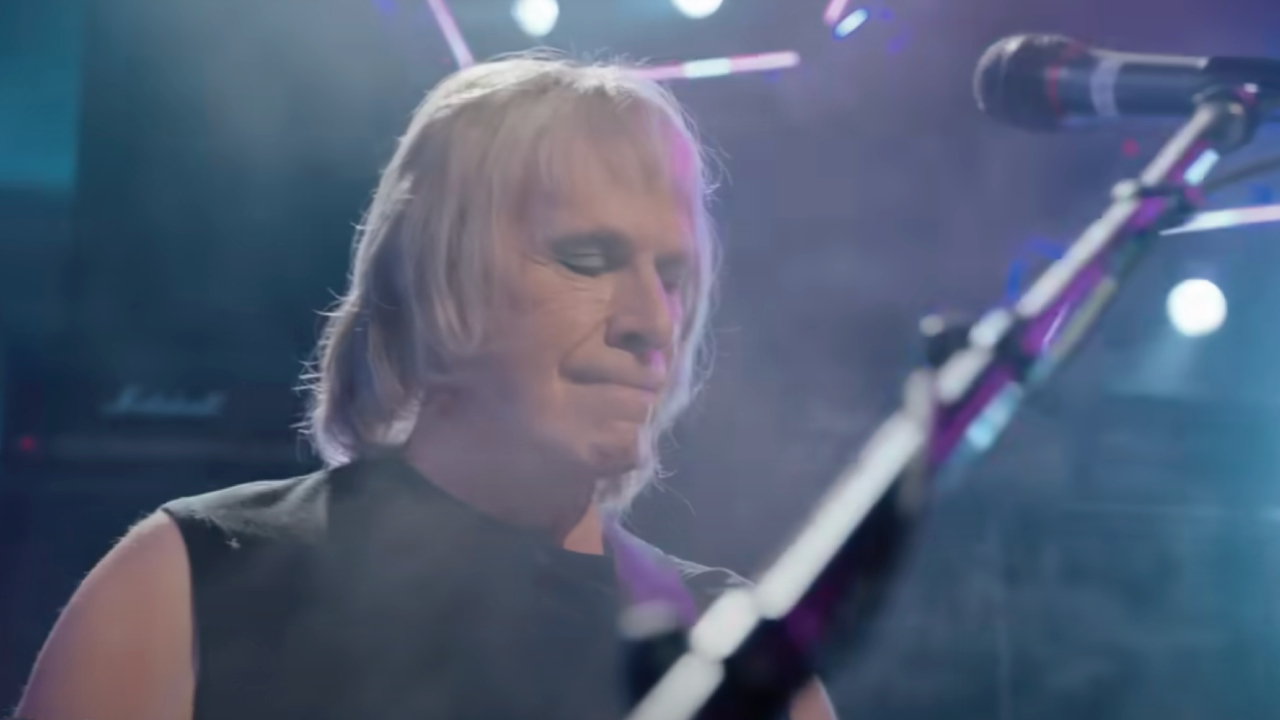 Christopher Guest as Nigel surrounding by smoke while performing in Spinal Tap II: The End Continues
