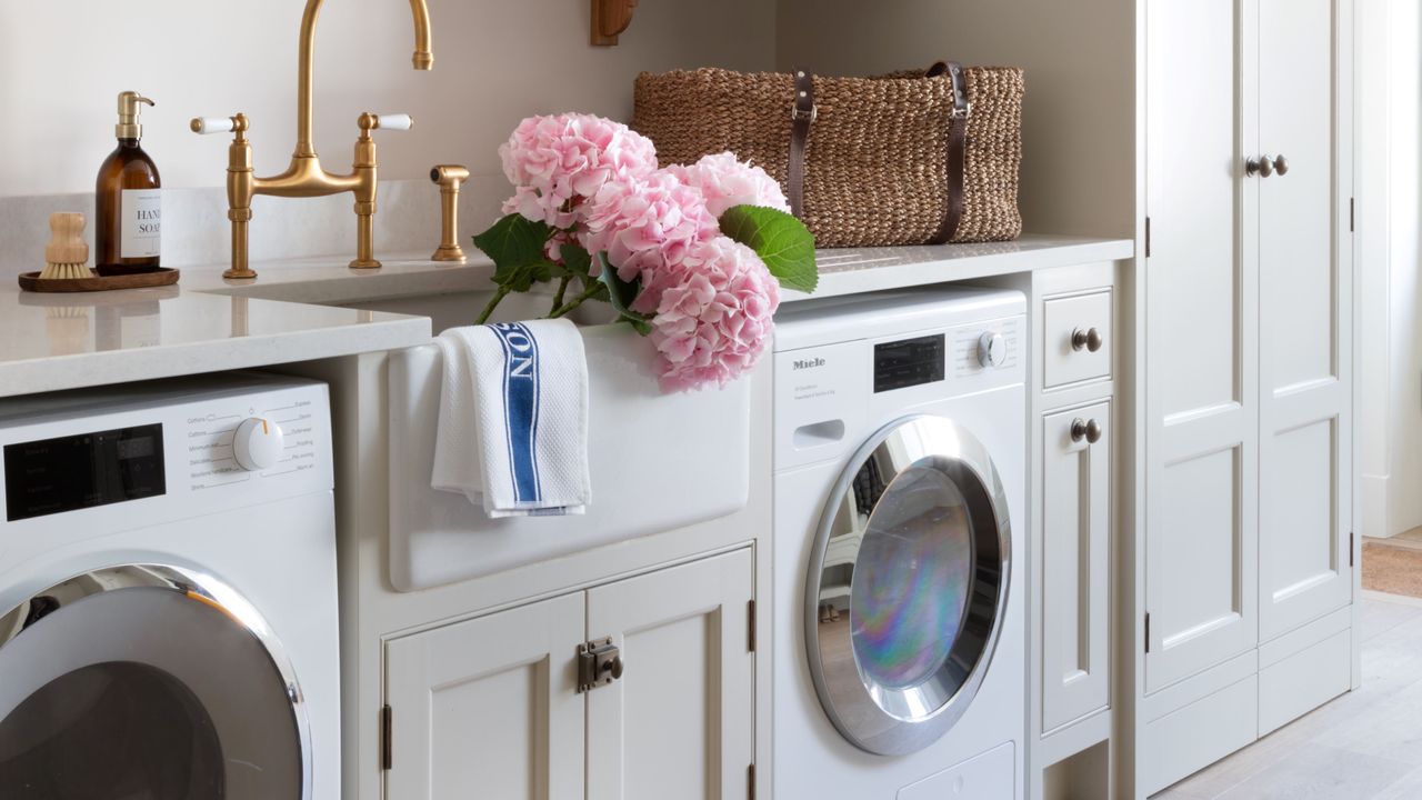 White kitchen with wood accents and fitted washing machine