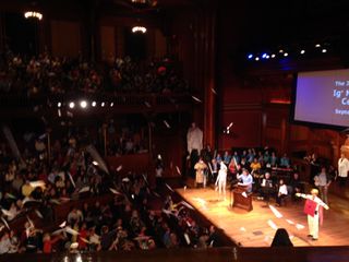 Paper airplanes fly during the 2014 Ig Nobel Prize ceremony.