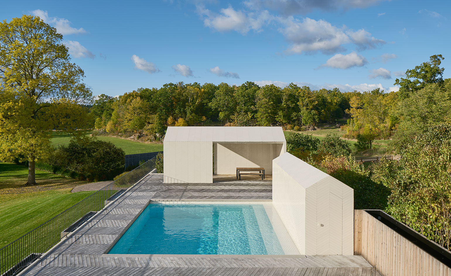 The complex includes a pool and two simple structures​