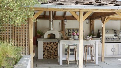 Outdoor kitchen with island and pergola