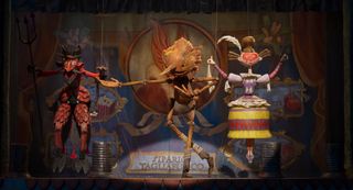 Pinocchio (voiced by Gregory Mann) on stage performing with marionettes in Guillermo del Toro's Pinocchio.