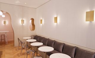 Seating area inside the restaurant showing long soft bench with tables & chairs