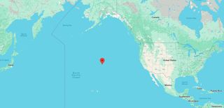 a map of Earth showing a red marker in the middle of the Pacific Ocean north of Hawaii