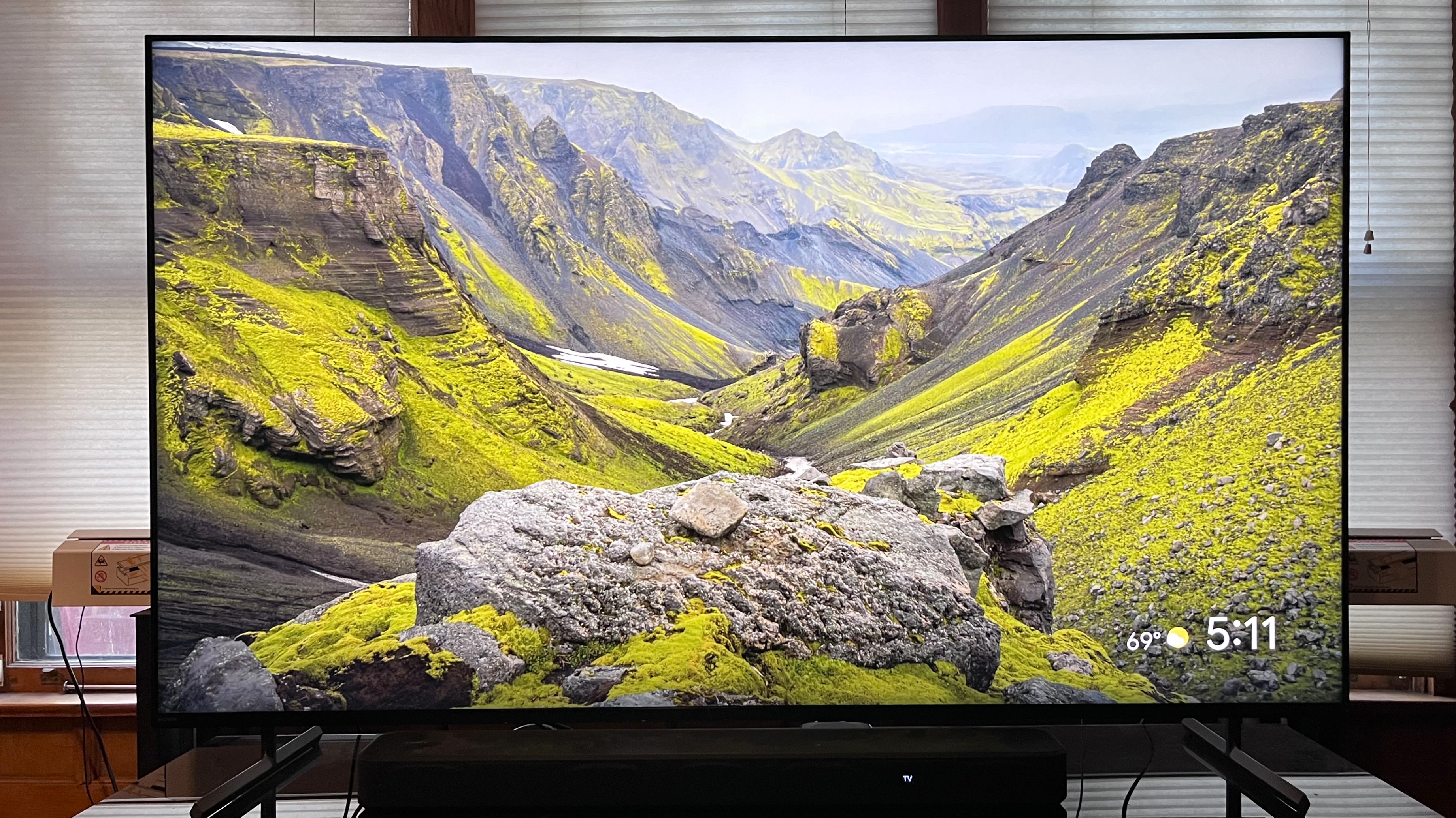 Sony X90L showing image of green valley on screen