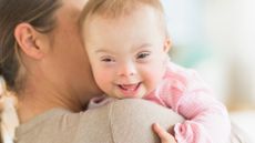 Woman holding a child with Down syndrome