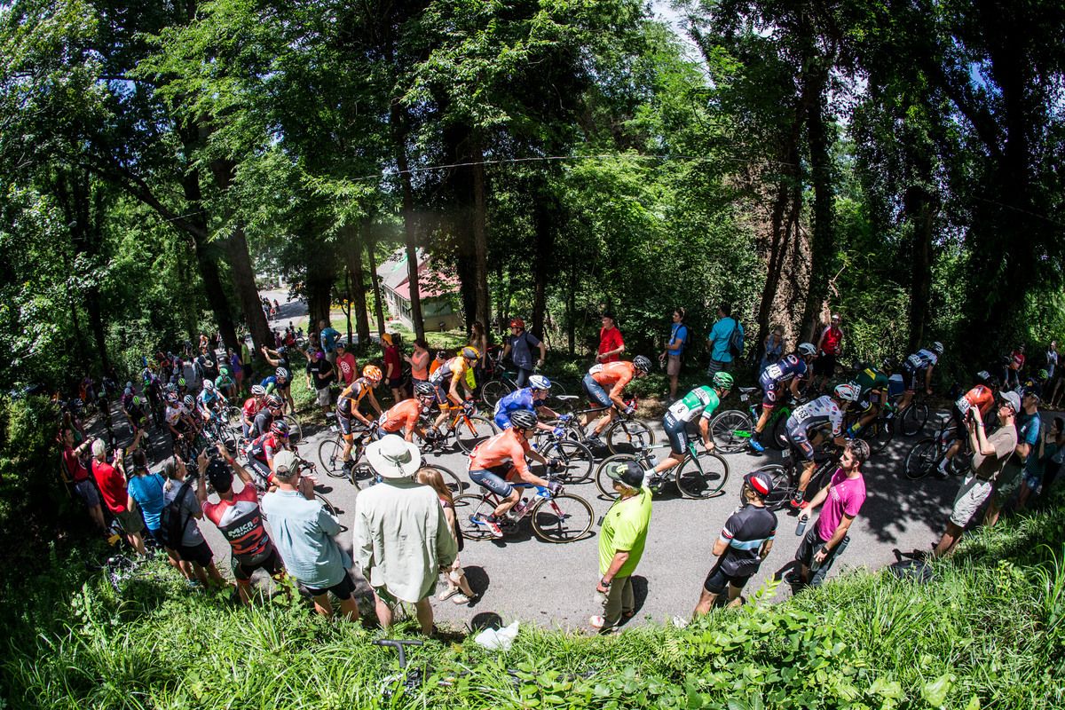 Riders go over the top of the climb