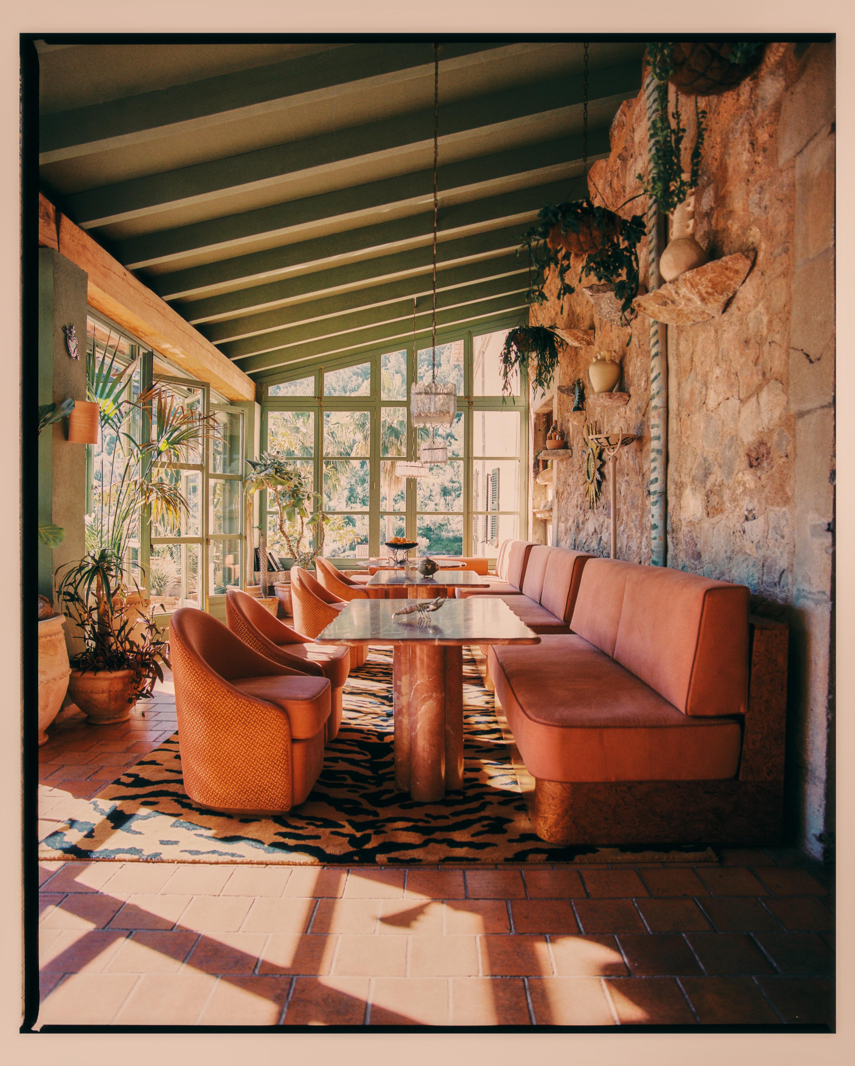 upholstered seating, tables and steel frame chairs on sunny terrace restaurant
