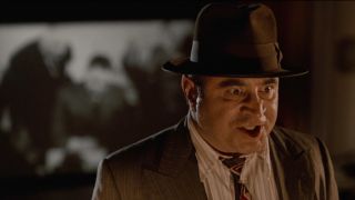 Bob Hoskins stands angrily in a movie theater in Who Framed Roger Rabbit.