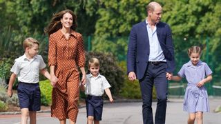 Prince George, Princess Charlotte and Prince Louis (C), accompanied by their parents Prince William and Catherine, Princess of Wales, arrive for a settling in afternoon at Lambrook School on September 7, 2022