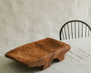 A chunky wooden platter by Vince Skelly, with a textured and chiselled motif on the surface