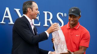 Matt Kuchar hands Tiger Woods The Players Championship trophy after his 2013 victory