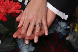 Princess Eugenie's hand holding husband Jack Brooksbank's and showing off her engagement ring