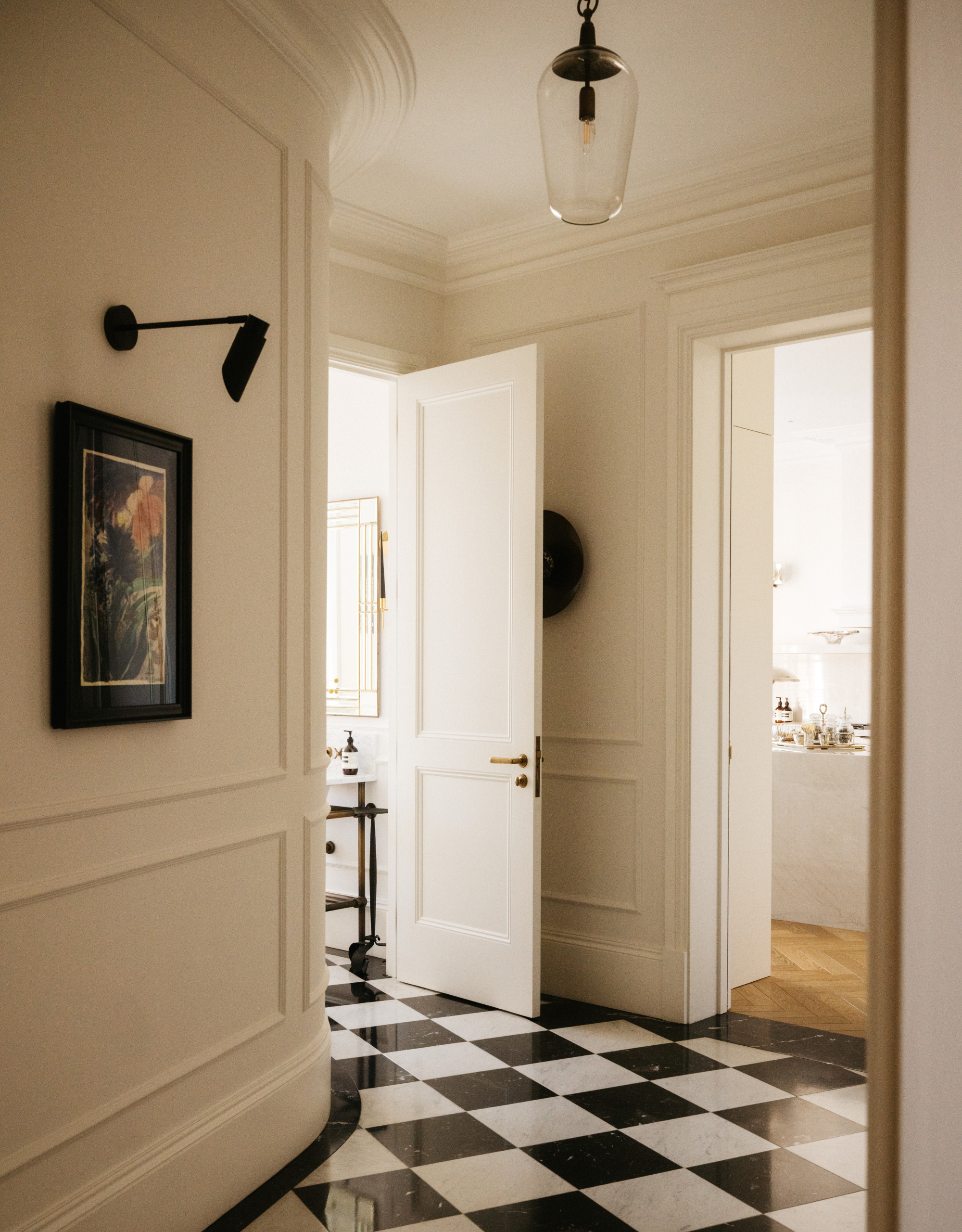 beautiful, grand entryway with black and white checkerboard floors, panelled walls and elegant finishes