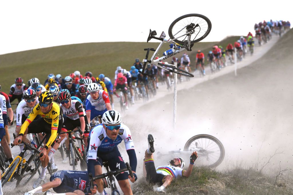 SIENA ITALY MARCH 05 LR Tiesj Benoot of Belgium and Team Jumbo Visma Lewis Askey of United Kingdom and Team Groupama FDJ Tadej Pogacar of Slovenia and UAE Team Emirates Stefano Oldani of Italy and Team AlpecinFenix and Julian Alaphilippe of France and Team QuickStep Alpha Vinyl being involved in a crash during the Eroica 16th Strade Bianche 2022 Mens Elite a 184km one day race from Siena to Siena Piazza del Campo 321m StradeBianche WorldTour on March 05 2022 in Siena Italy Photo by Tim de WaeleGetty Images