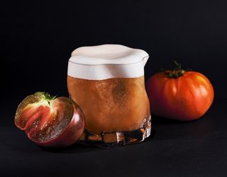 Tomatoes beside a cocktail glass