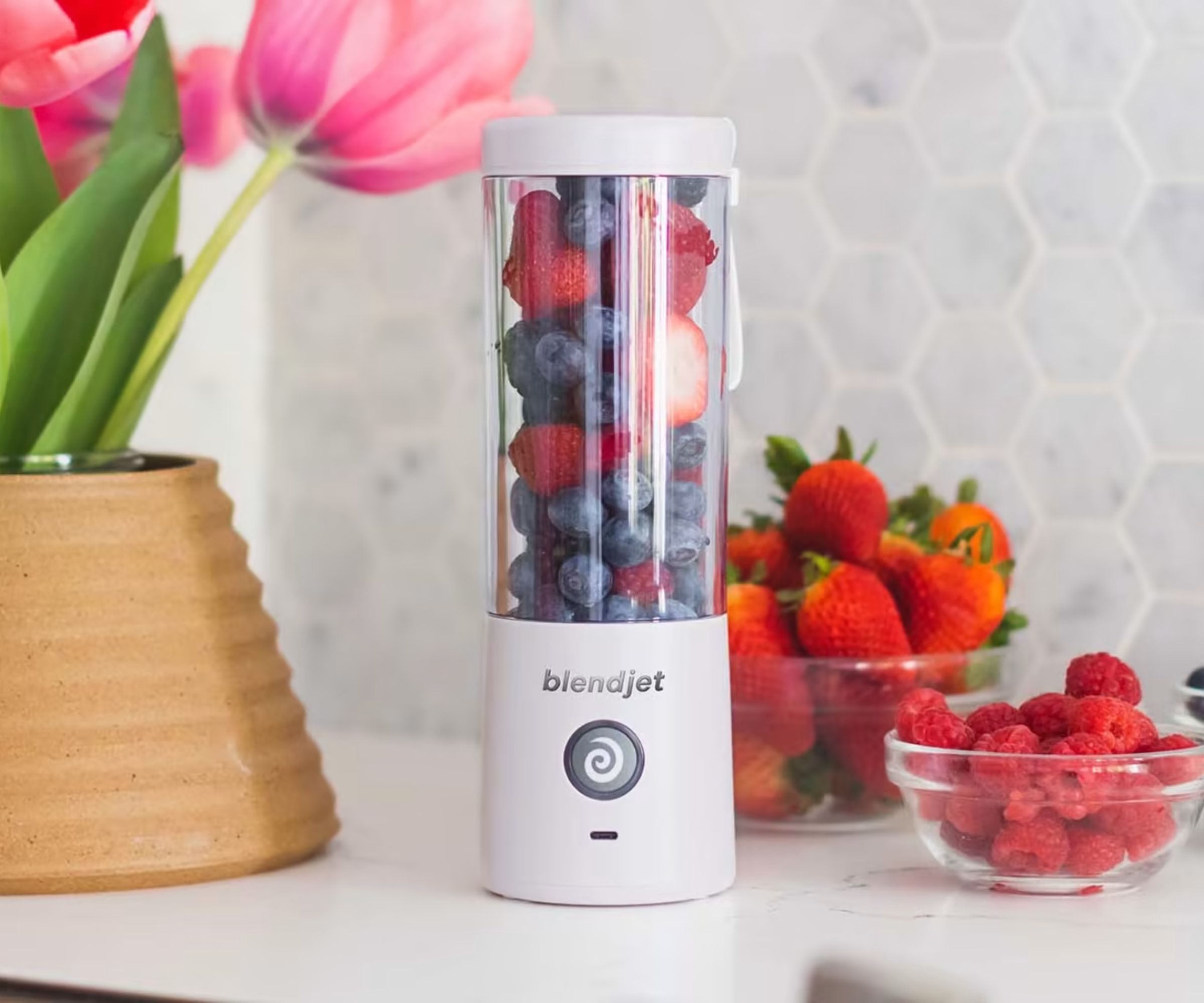 A BlendJet 2 in white with berries in a kitchen