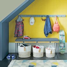 Yellow hallway with bench and storage baskets for shoes and accessories